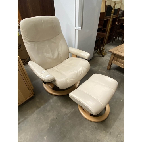 Cream leather Ekornes reclining swivel chair with matching footstool