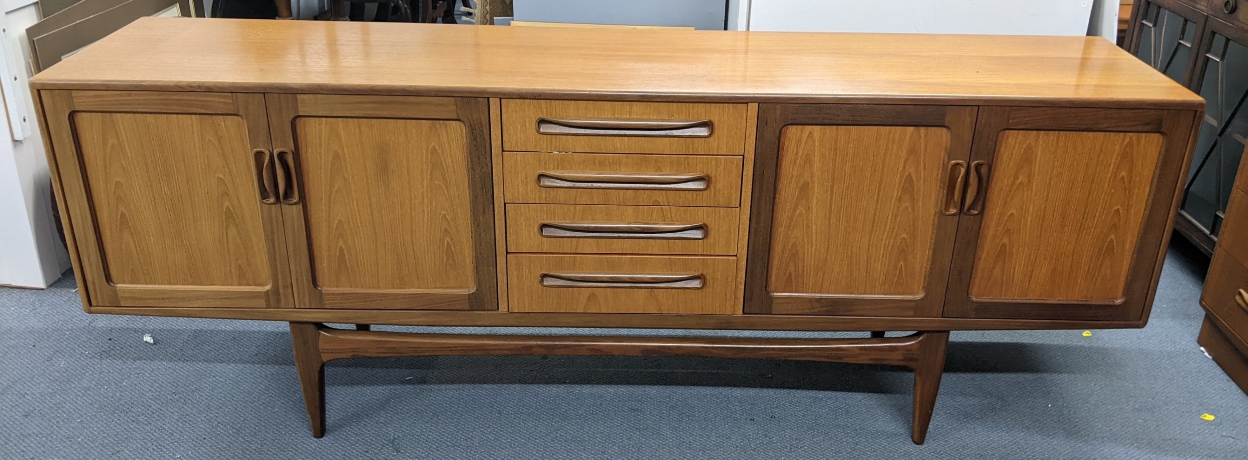 Long G-Plan Fresco teak sideboard with central drawers and cupboard doors designed by Victor Wilkins