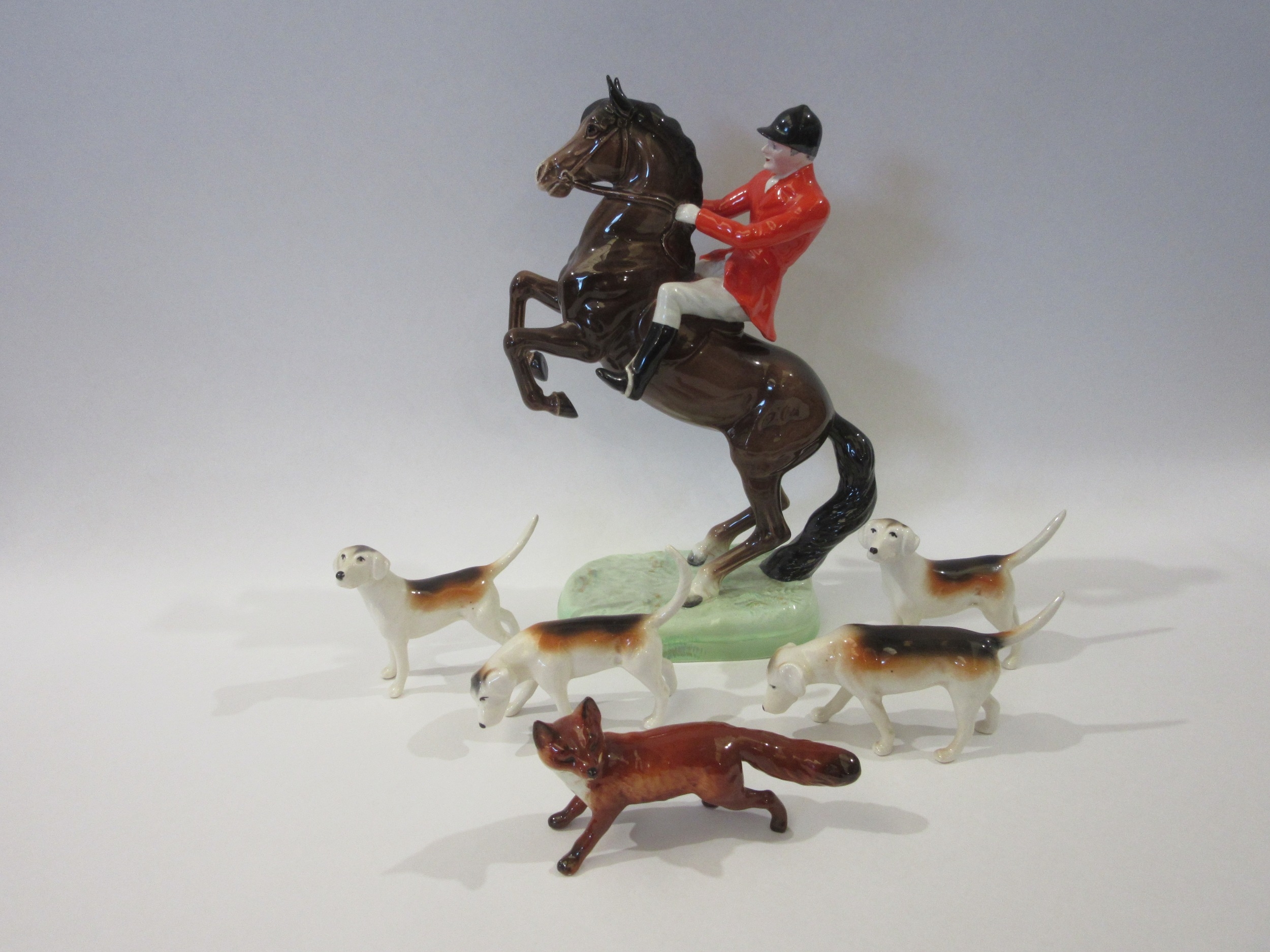 Beswick huntsman on rearing horse with four foxhounds and a fox in gloss finish