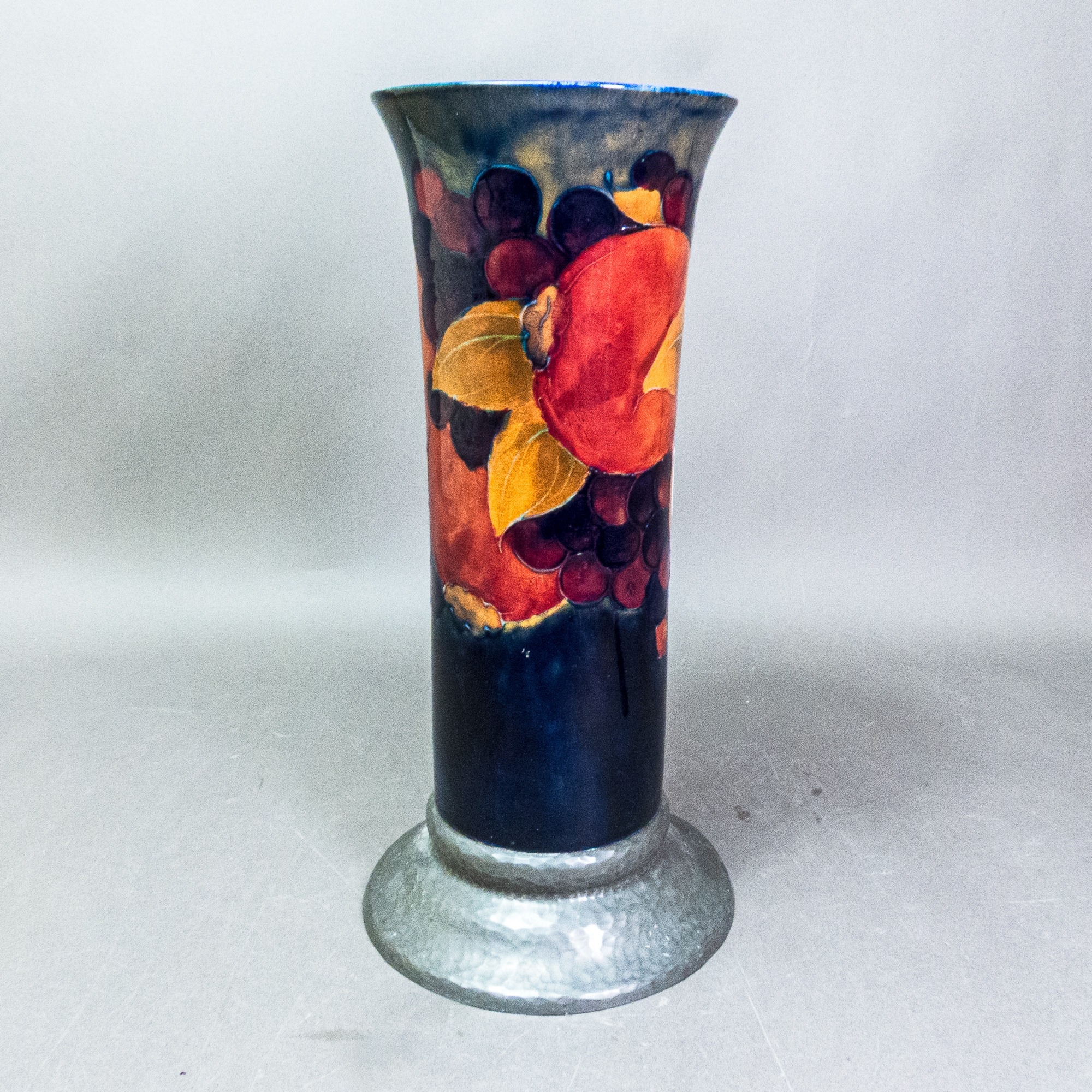 Large Moorcroft Pomegranate pattern cylindrical vase with flared rim on a pewter base