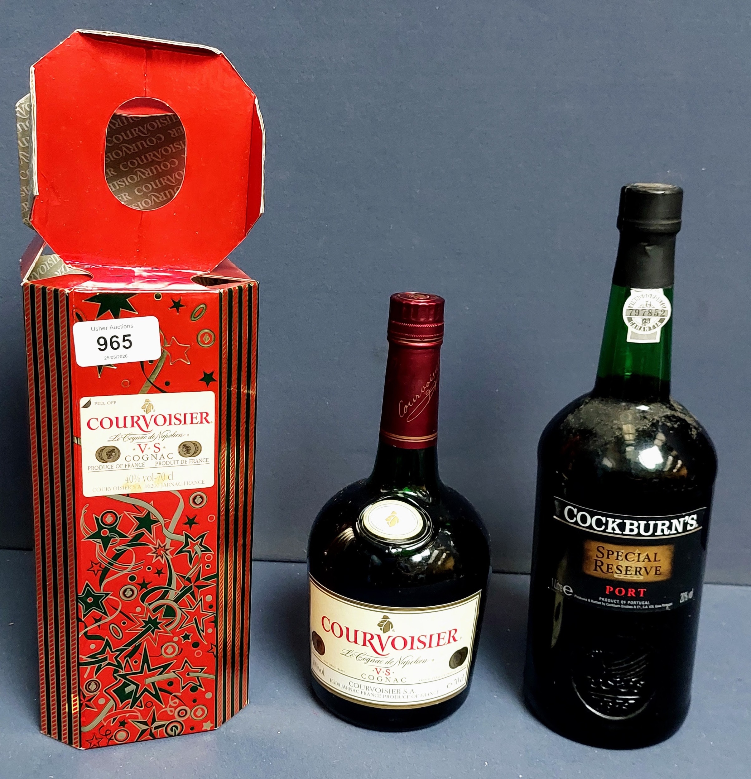 Boxed bottle of Courvoisier cognac beside a bottle of Cockburn’s Special Reserve port