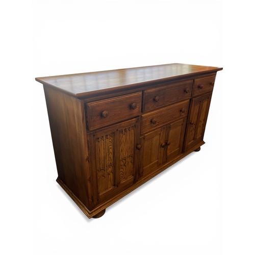 Ercol Golden Dawn sideboard with three drawers above cupboard doors