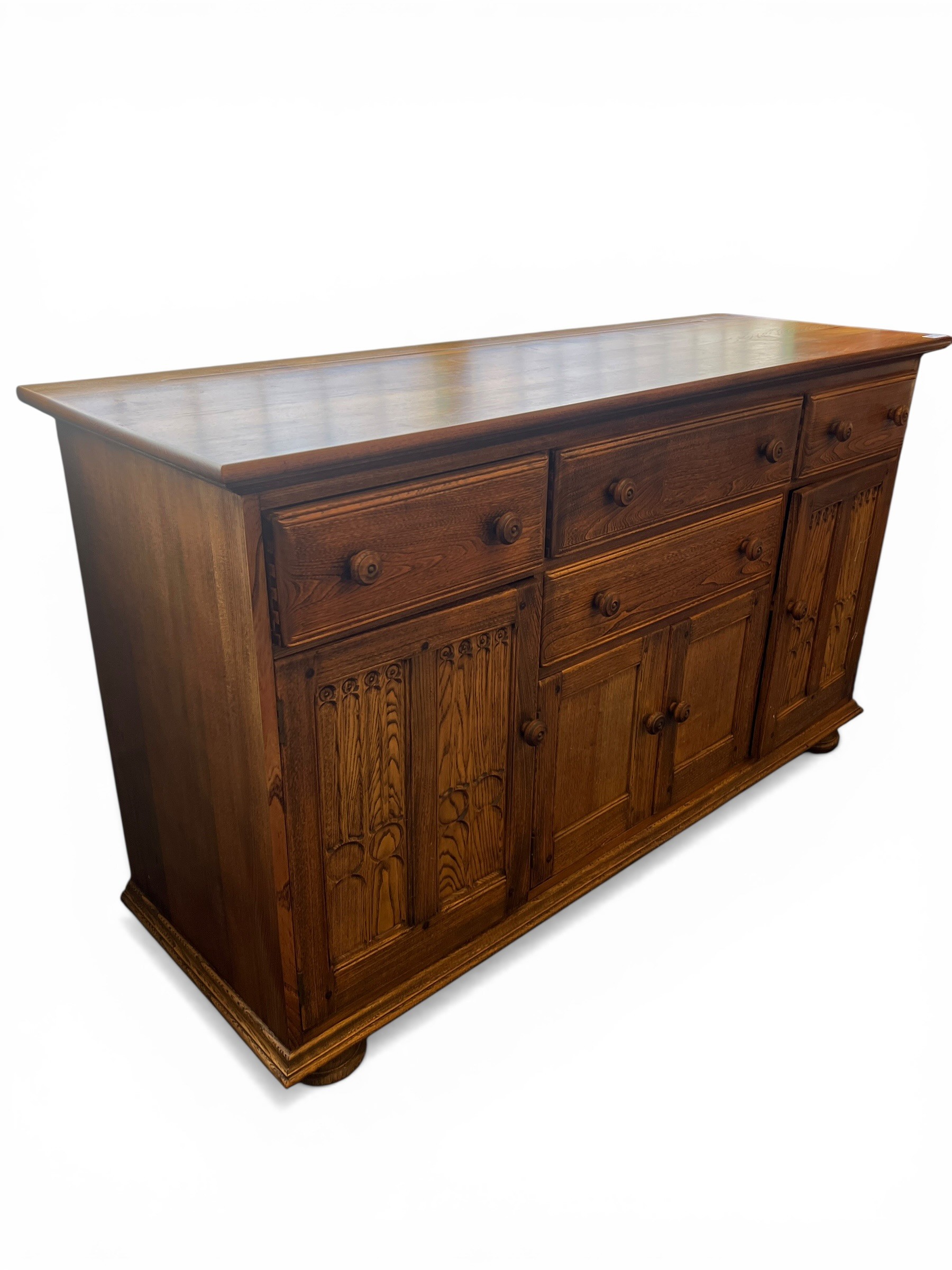 Ercol Golden Dawn sideboard with three drawers above cupboard doors