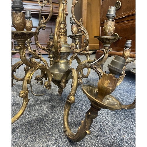 Gilded twelve-branch chandelier adapted for electricity with scrolling arms and candle-style fittings