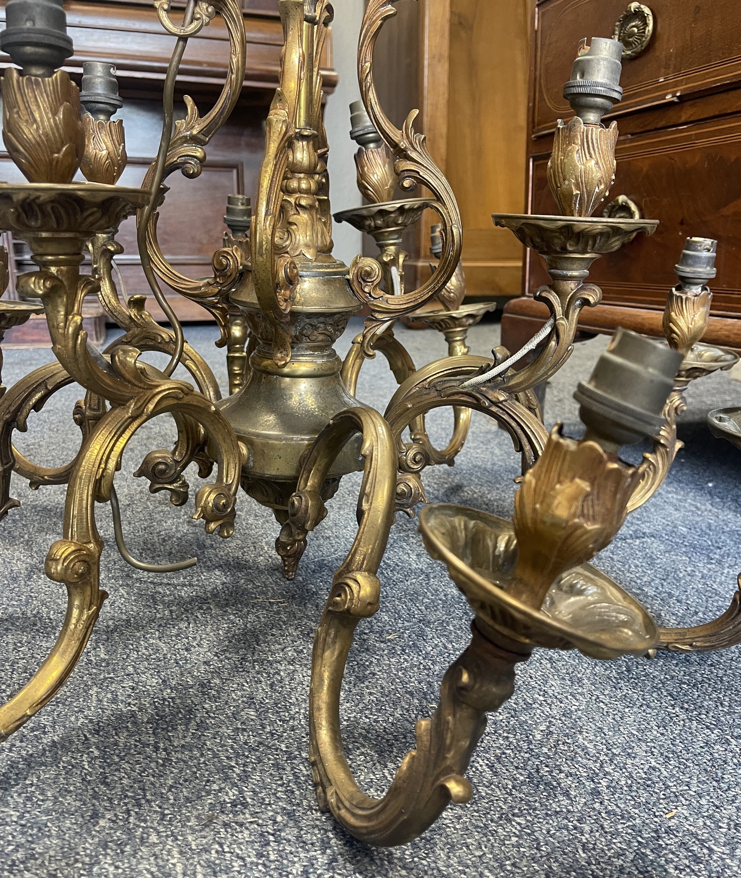 Gilded twelve-branch chandelier adapted for electricity with scrolling arms and candle-style fittings