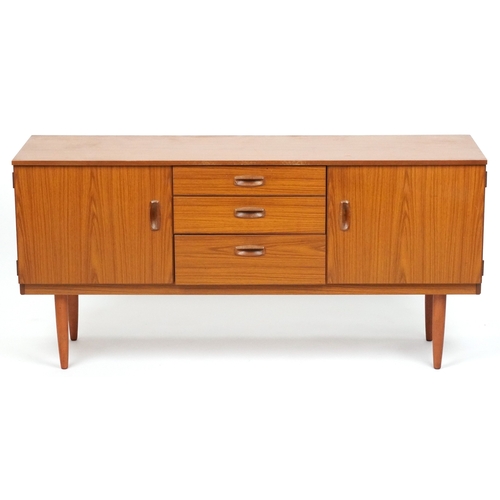 Mid-century Schreiber teak sideboard with three central drawers, paired cupboard doors, and tapering legs