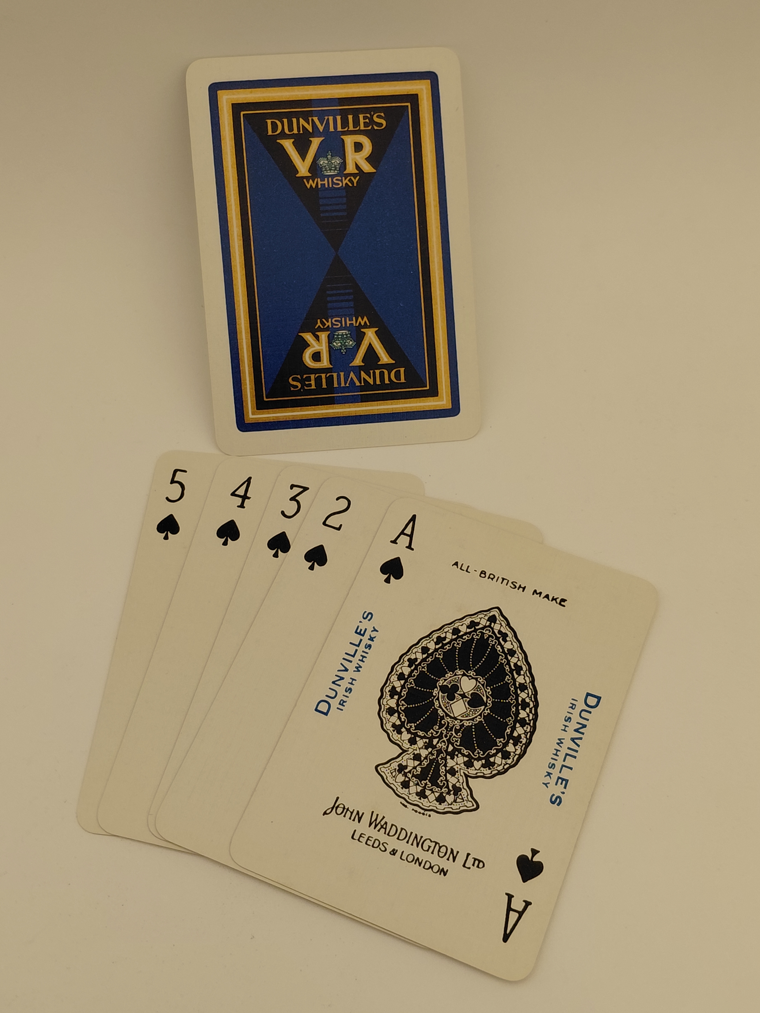 Dunville's VR Whiskey playing cards with branded tuck box and a small fan of spade cards