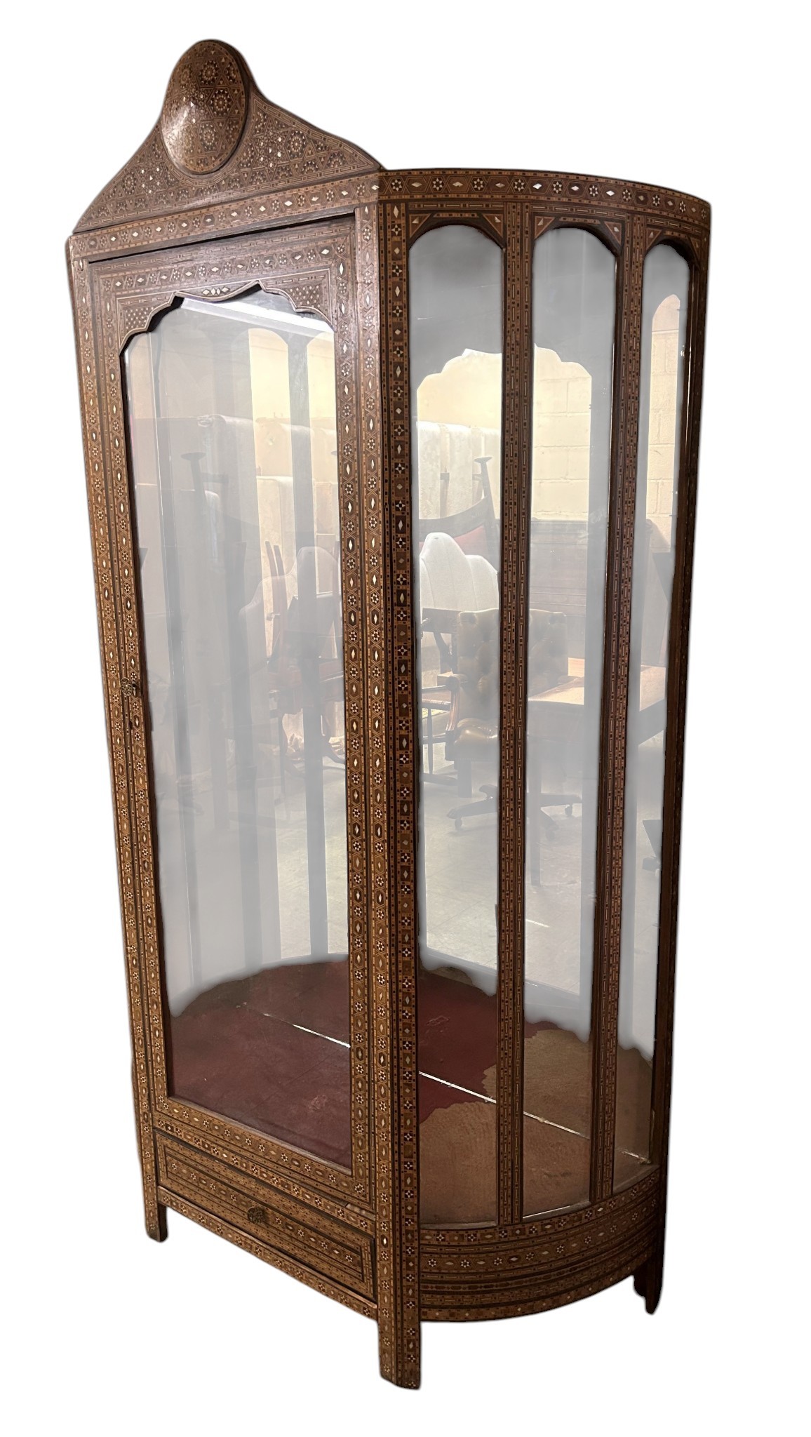 Tall Damascus inlaid display cabinet in the Moorish style with arched columns, a shaped pediment, and dense mother-of-pearl decoration
