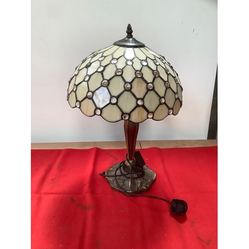 Vintage Tiffany-style table lamp with a cream stained-glass shade, clear bead jewels, and a dark bronze-patterned base