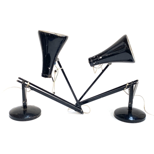 Pair of vintage black Herbert Terry Anglepoise lamps with rounded black bases, spring-balanced arms, chipped shades, and exposed wiring