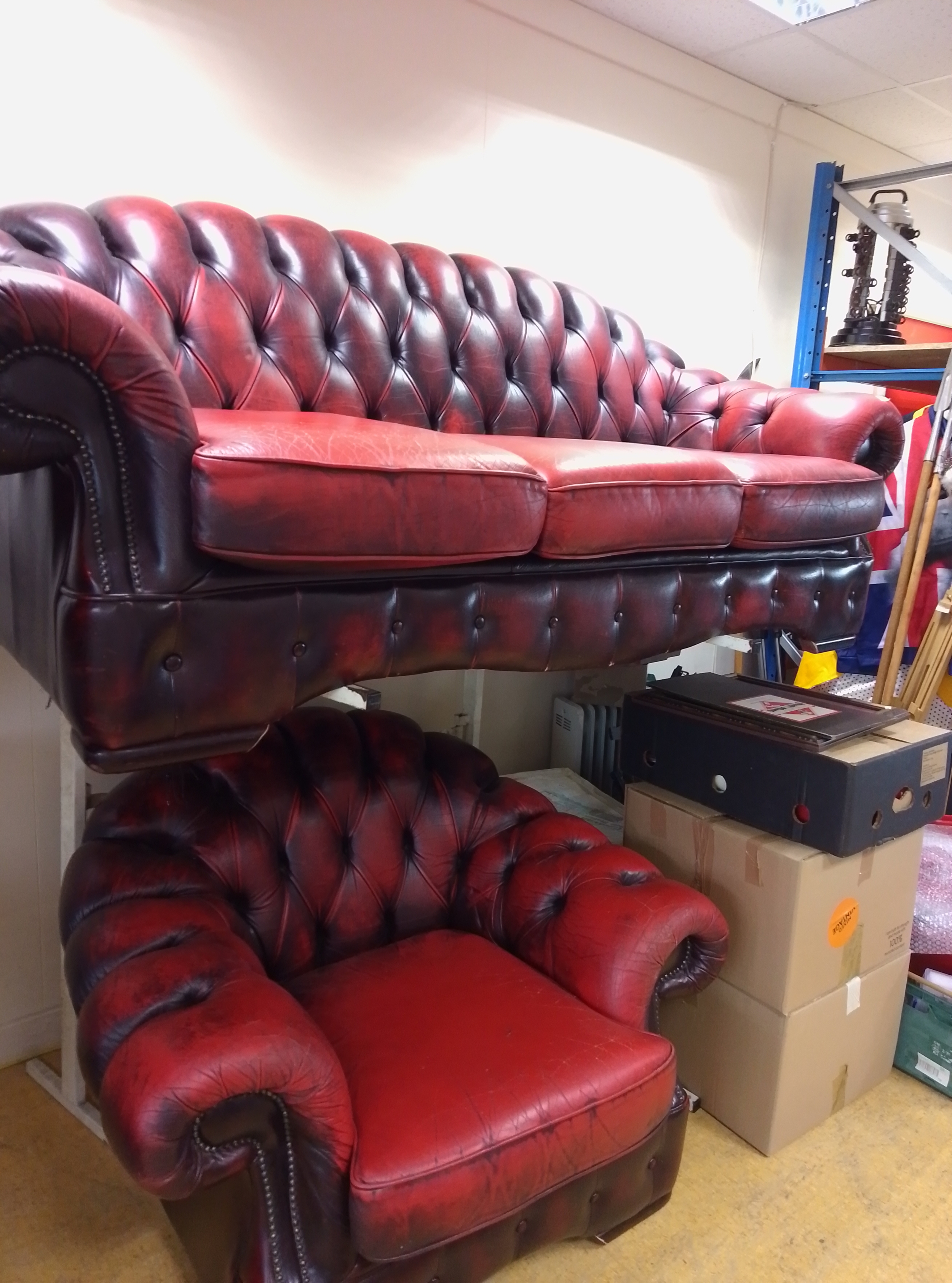 Chesterfield three-piece suite with a three-seater sofa and matching armchair in red buttoned upholstery