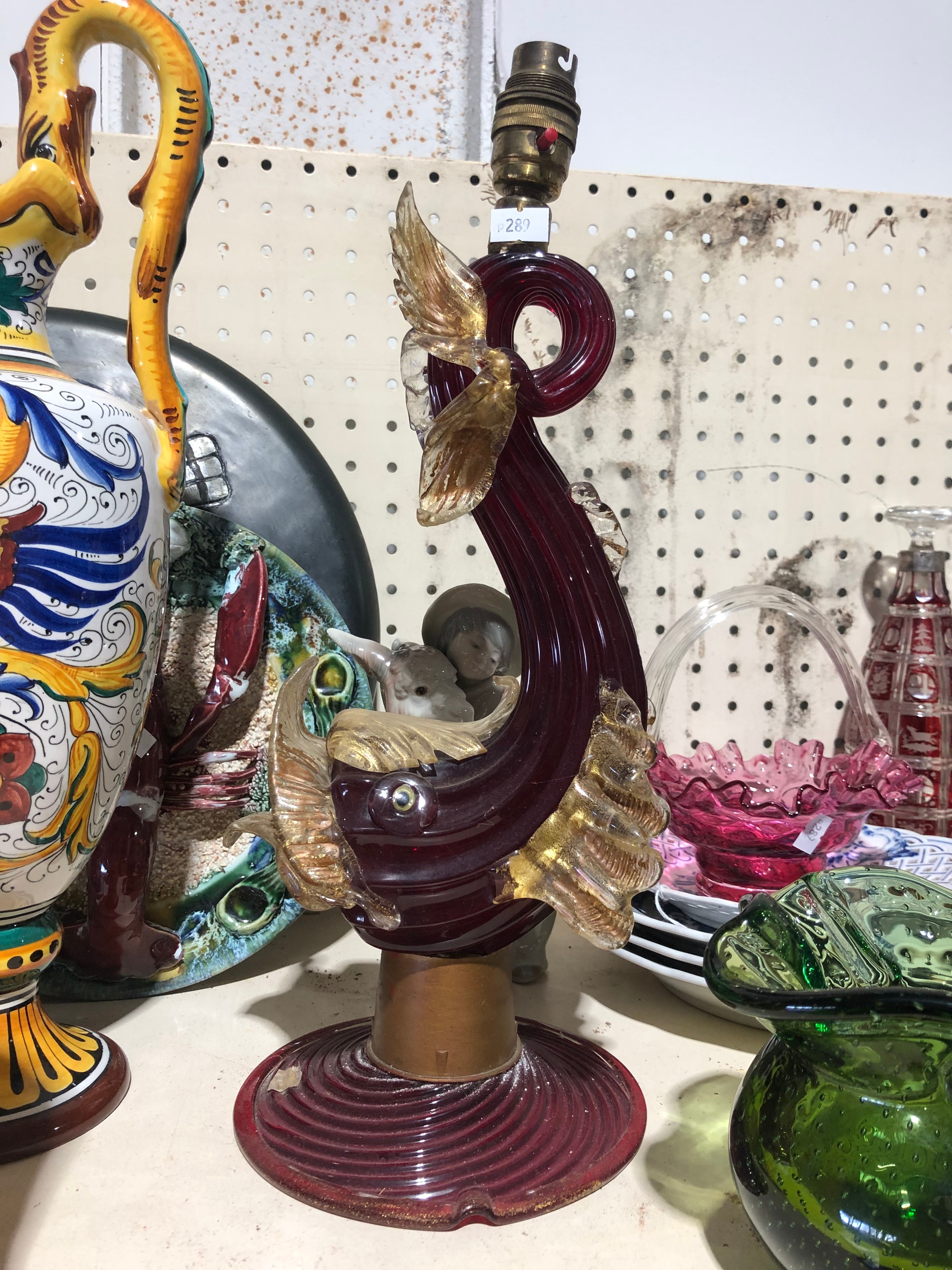 Ruby Murano glass sculptural table lamp with curled body, applied amber glass fish and fin details, and an older brass lamp fitting
