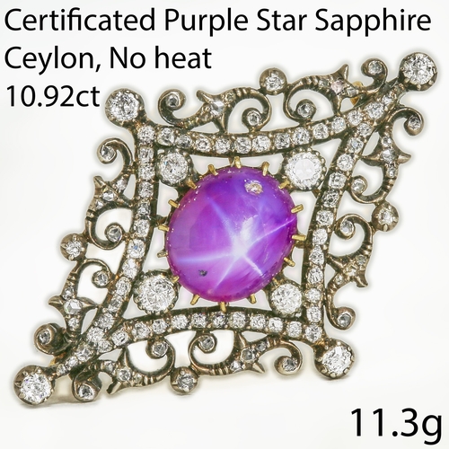 Victorian purple star sapphire and diamond brooch in an ornate openwork setting with scrolling foliate motifs