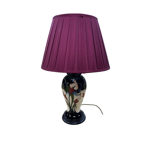 Moorcroft Calla Lily pattern table lamp with cream pleated shade and tube-lined white flowers rising over a blue-green ground