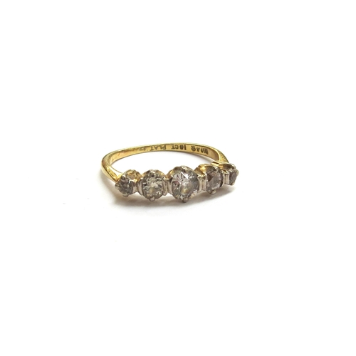 Five graduated diamonds mounted across the top of an 18ct gold and platinum ring in a classic five-stone arrangement