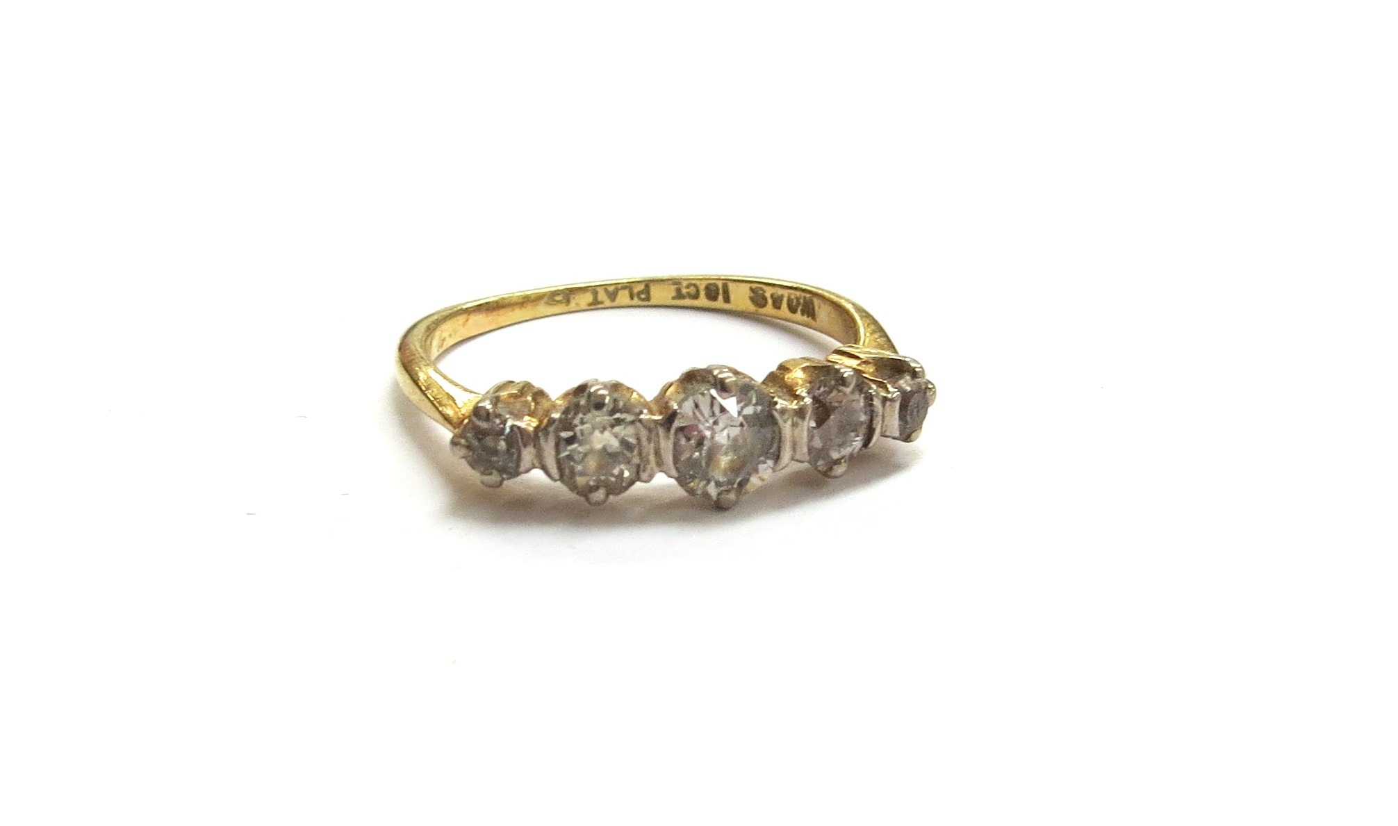 Five graduated diamonds mounted across the top of an 18ct gold and platinum ring in a classic five-stone arrangement