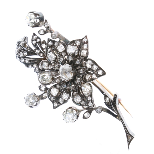 Antique floral diamond brooch in gold and silver, formed as a graduated flower spray with old cut stones and scrolling leaves