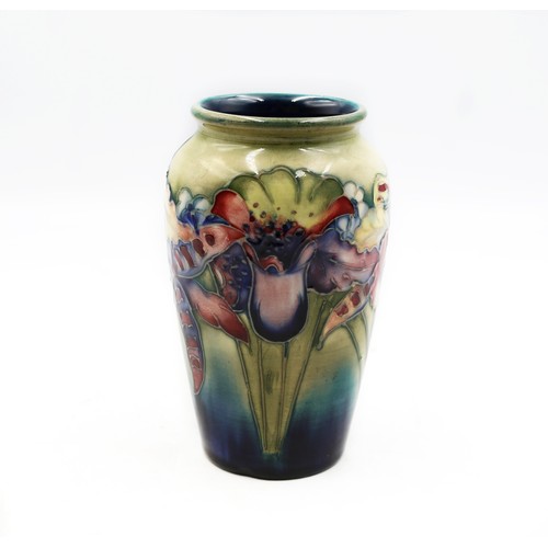 Small William Moorcroft Orchid vase with tubelined orchid blooms on a dark ground
