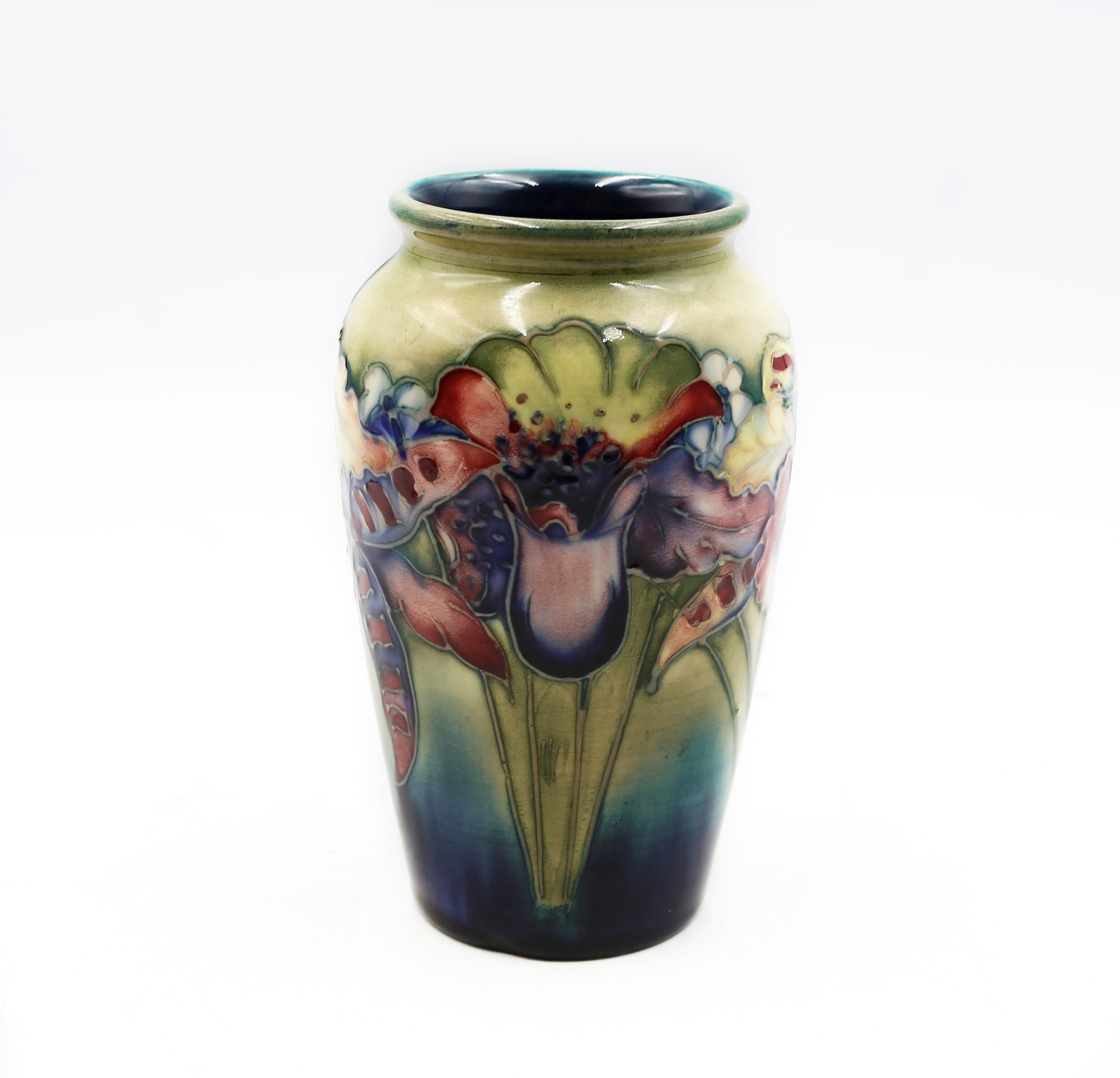 Small William Moorcroft Orchid vase with tubelined orchid blooms on a dark ground