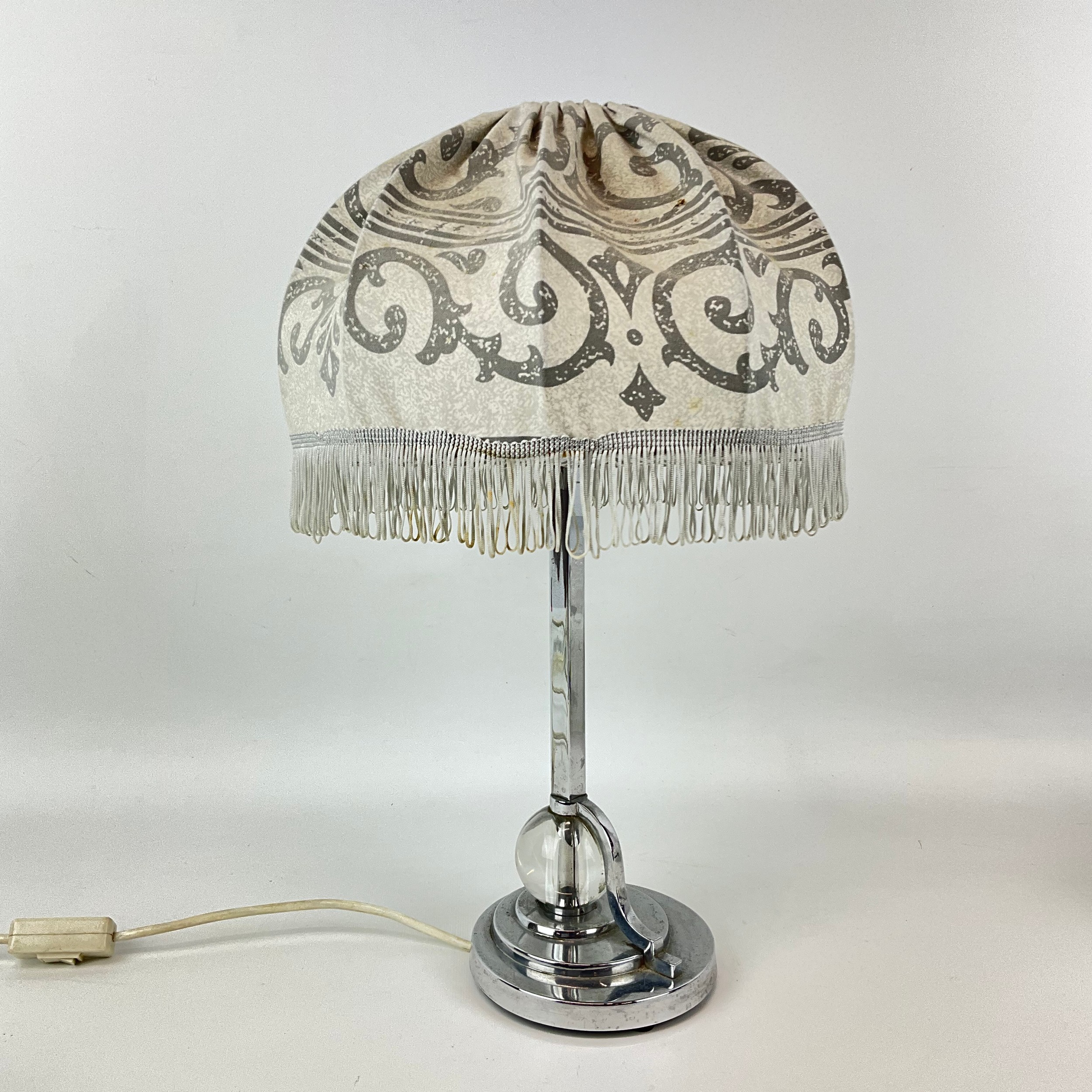 Chrome and glass Walkerlite table lamp with a domed fringed shade, round base, and clear glass orb detail