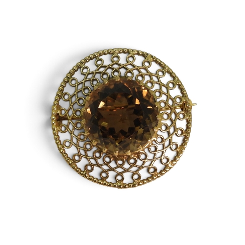 Circular 9ct gold filigree brooch by Robert Allison set with a large round smoky quartz